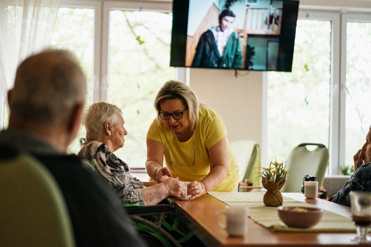 A caregiver assists a senior adult in a Karviná retirement home.